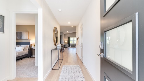 Entryway with a coat closet and laminate flooring