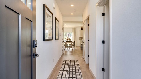 Entryway with a coat closet and laminate flooring