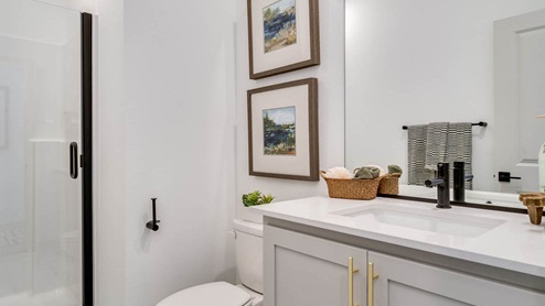 bathroom with quartz counters and a walk-in shower