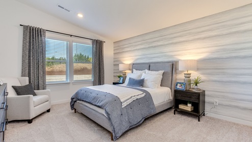 Primary bedroom with wall-to-wall carpet, a walk-in closet and an attached bathroom