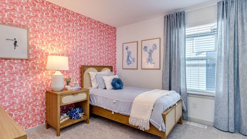 Bedroom with wall-to-wall carpet and a closet