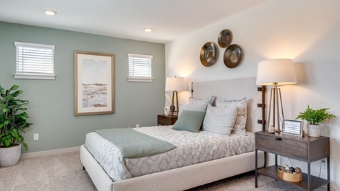 Primary bedroom with wall-to-wall carpet, a walk-in closet and an attached bathroom