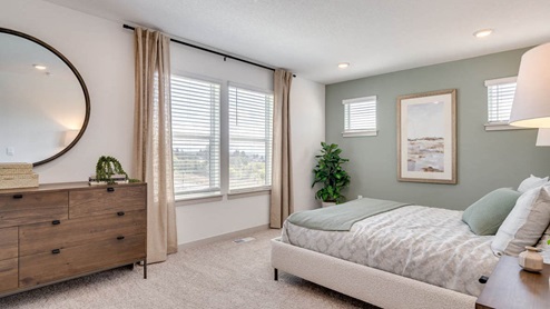 Primary bedroom with wall-to-wall carpet, a walk-in closet and an attached bathroom