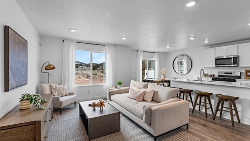 The Millbrook floor plan's living room on the main floor boasts a large window and plenty of room for lounging or entertaining.