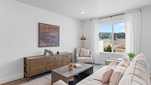 The Millbrook floor plan's living room on the main floor boasts a large window and plenty of room for lounging or entertaining.