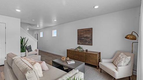 The Millbrook floor plan's living room on the main floor boasts a large window and plenty of room for lounging or entertaining.