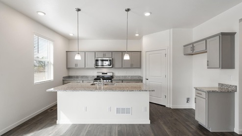 gray cabinet kitchen with an island