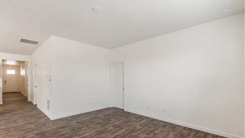 living room with white walls and wood floor