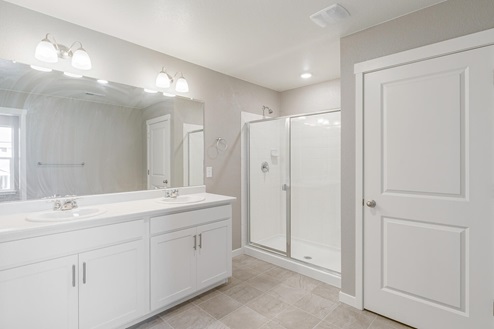 dual sink bathroom with white cabinet