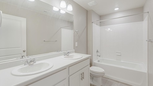 white cabinet bathroom with a tub