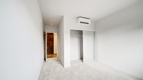 Interior bedroom with full length door mirrors