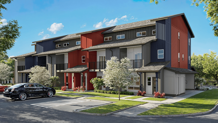 Exterior three story condominium with red and gray wood cladding