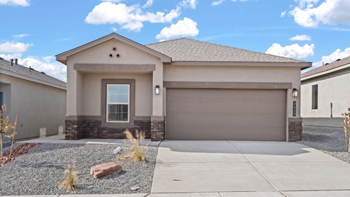 Sawyer exterior with brown stucco, concrete driveway, 2-car garage, and landscsaping