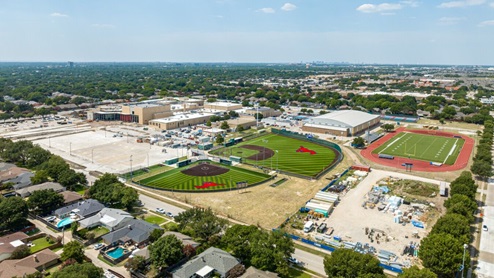 Wide shot of JJ Pearce High School campus in Richardson, TX, showing athletic fields and school facilities
