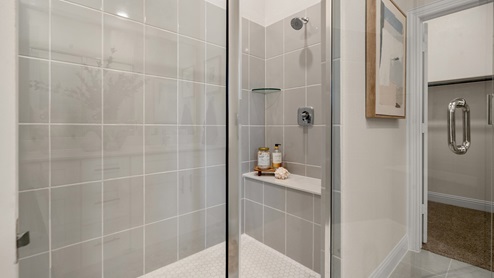 Bathroom with shower with gray tile