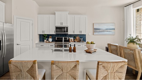 Kitchen with island and white cabinets
