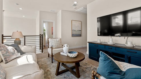 Upstairs loft area with chairs and tv