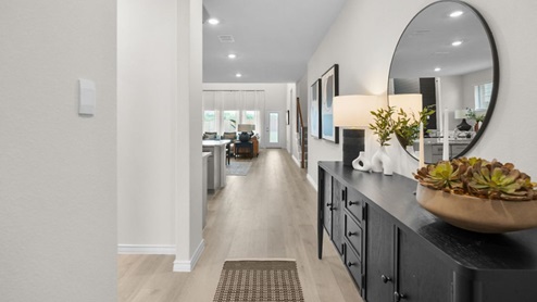 Interior hallway leading to kitchen and living area