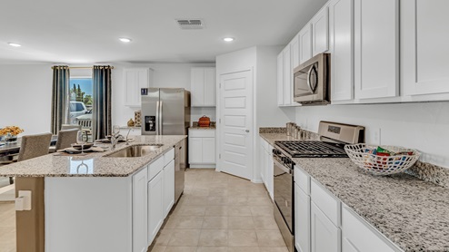 Welcome to Senita Crossing, a premier new home community by D.R. Horton, located in Tucson’s thriving southeast side. These thoughtfully crafted 3- and 4-bedroom new homes range from 1,200 to 2,200 square feet, providing the perfect blend of comfort and modern design. With easy access to I-10, Senita Crossing is conveniently situated near Davis-Monthan Air Force Base, the University of Arizona, and major employers like Raytheon, making it an ideal choice for families and professionals alike.  Each new home in Senita Crossing is designed with spacious living in mind, offering large, fully fenced backyards, covered patios, and inviting front porches. Inside, you’ll find elegant 12”x12” ceramic tile flooring throughout most areas, complemented by granite countertops and stylish Shaker cabinetry. Modern conveniences include stainless steel appliances such as a gas range, microwave, and dishwasher, all designed to enhance your daily living experience. Additionally, the Home is Connected® Smart Home package, which includes a smart thermostat, video doorbell, keyless entry, and more ensures that your home is as functional as it is beautiful.  Energy efficiency is a cornerstone of Senita Crossing’s new homes, which are DOE Zero Energy Ready. These homes feature tankless water heaters, LED lighting, and advanced spray foam insulation to ensure lower energy costs and a smaller carbon footprint, offering you a sustainable and cost-effective living environment. The community itself is designed with families in mind, featuring a park with a playground, a ramada, and a grassy common area, as well as a maintained bike and walking trail that connects to McCain Loop, providing ample opportunities for outdoor recreation.  Senita Crossing is located within the highly regarded Sunnyside Unified School District, offering access to top-rated schools such as Los Niños Elementary, Lauffer Middle School, and Desert View High School. For those seeking specialized education, the nearby Gallego Primary Fine Arts Magnet School is an excellent option for families. The community’s prime location ensures that you are never far from the essentials. With I-10 nearby, commuting is a breeze, and Tucson International Airport is just minutes away. Residents will also enjoy convenient access to shopping centers, local Carnecerias, and dining in some of the best restaurants in Tucson.  For those who appreciate outdoor activities and cultural attractions, Senita Crossing is just a short drive from Sabino Canyon, Reid Park Zoo, Tucson Botanical Gardens, and Kino Sports Complex. At Senita Crossing, D.R. Horton’s commitment to quality and innovative design is evident in every detail. Discover your ideal home in a community that offers everything you need to live your best life.