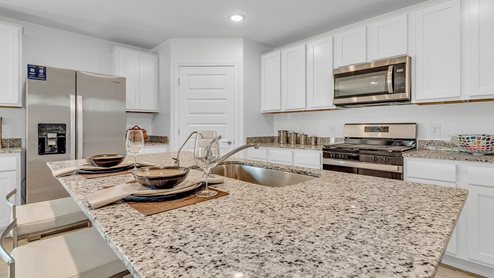 Welcome to Senita Crossing, a premier new home community by D.R. Horton, located in Tucson’s thriving southeast side. These thoughtfully crafted 3- and 4-bedroom new homes range from 1,200 to 2,200 square feet, providing the perfect blend of comfort and modern design. With easy access to I-10, Senita Crossing is conveniently situated near Davis-Monthan Air Force Base, the University of Arizona, and major employers like Raytheon, making it an ideal choice for families and professionals alike.  Each new home in Senita Crossing is designed with spacious living in mind, offering large, fully fenced backyards, covered patios, and inviting front porches. Inside, you’ll find elegant 12”x12” ceramic tile flooring throughout most areas, complemented by granite countertops and stylish Shaker cabinetry. Modern conveniences include stainless steel appliances such as a gas range, microwave, and dishwasher, all designed to enhance your daily living experience. Additionally, the Home is Connected® Smart Home package, which includes a smart thermostat, video doorbell, keyless entry, and more ensures that your home is as functional as it is beautiful.  Energy efficiency is a cornerstone of Senita Crossing’s new homes, which are DOE Zero Energy Ready. These homes feature tankless water heaters, LED lighting, and advanced spray foam insulation to ensure lower energy costs and a smaller carbon footprint, offering you a sustainable and cost-effective living environment. The community itself is designed with families in mind, featuring a park with a playground, a ramada, and a grassy common area, as well as a maintained bike and walking trail that connects to McCain Loop, providing ample opportunities for outdoor recreation.  Senita Crossing is located within the highly regarded Sunnyside Unified School District, offering access to top-rated schools such as Los Niños Elementary, Lauffer Middle School, and Desert View High School. For those seeking specialized education, the nearby Gallego Primary Fine Arts Magnet School is an excellent option for families. The community’s prime location ensures that you are never far from the essentials. With I-10 nearby, commuting is a breeze, and Tucson International Airport is just minutes away. Residents will also enjoy convenient access to shopping centers, local Carnecerias, and dining in some of the best restaurants in Tucson.  For those who appreciate outdoor activities and cultural attractions, Senita Crossing is just a short drive from Sabino Canyon, Reid Park Zoo, Tucson Botanical Gardens, and Kino Sports Complex. At Senita Crossing, D.R. Horton’s commitment to quality and innovative design is evident in every detail. Discover your ideal home in a community that offers everything you need to live your best life.