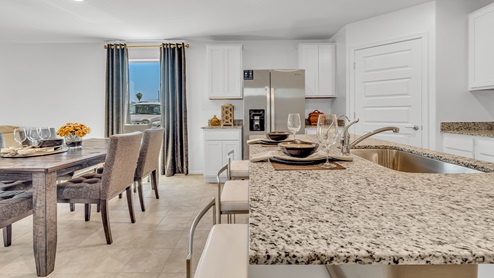 Welcome to Senita Crossing, a premier new home community by D.R. Horton, located in Tucson’s thriving southeast side. These thoughtfully crafted 3- and 4-bedroom new homes range from 1,200 to 2,200 square feet, providing the perfect blend of comfort and modern design. With easy access to I-10, Senita Crossing is conveniently situated near Davis-Monthan Air Force Base, the University of Arizona, and major employers like Raytheon, making it an ideal choice for families and professionals alike.  Each new home in Senita Crossing is designed with spacious living in mind, offering large, fully fenced backyards, covered patios, and inviting front porches. Inside, you’ll find elegant 12”x12” ceramic tile flooring throughout most areas, complemented by granite countertops and stylish Shaker cabinetry. Modern conveniences include stainless steel appliances such as a gas range, microwave, and dishwasher, all designed to enhance your daily living experience. Additionally, the Home is Connected® Smart Home package, which includes a smart thermostat, video doorbell, keyless entry, and more ensures that your home is as functional as it is beautiful.  Energy efficiency is a cornerstone of Senita Crossing’s new homes, which are DOE Zero Energy Ready. These homes feature tankless water heaters, LED lighting, and advanced spray foam insulation to ensure lower energy costs and a smaller carbon footprint, offering you a sustainable and cost-effective living environment. The community itself is designed with families in mind, featuring a park with a playground, a ramada, and a grassy common area, as well as a maintained bike and walking trail that connects to McCain Loop, providing ample opportunities for outdoor recreation.  Senita Crossing is located within the highly regarded Sunnyside Unified School District, offering access to top-rated schools such as Los Niños Elementary, Lauffer Middle School, and Desert View High School. For those seeking specialized education, the nearby Gallego Primary Fine Arts Magnet School is an excellent option for families. The community’s prime location ensures that you are never far from the essentials. With I-10 nearby, commuting is a breeze, and Tucson International Airport is just minutes away. Residents will also enjoy convenient access to shopping centers, local Carnecerias, and dining in some of the best restaurants in Tucson.  For those who appreciate outdoor activities and cultural attractions, Senita Crossing is just a short drive from Sabino Canyon, Reid Park Zoo, Tucson Botanical Gardens, and Kino Sports Complex. At Senita Crossing, D.R. Horton’s commitment to quality and innovative design is evident in every detail. Discover your ideal home in a community that offers everything you need to live your best life.