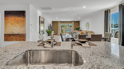 Welcome to Senita Crossing, a premier new home community by D.R. Horton, located in Tucson’s thriving southeast side. These thoughtfully crafted 3- and 4-bedroom new homes range from 1,200 to 2,200 square feet, providing the perfect blend of comfort and modern design. With easy access to I-10, Senita Crossing is conveniently situated near Davis-Monthan Air Force Base, the University of Arizona, and major employers like Raytheon, making it an ideal choice for families and professionals alike.  Each new home in Senita Crossing is designed with spacious living in mind, offering large, fully fenced backyards, covered patios, and inviting front porches. Inside, you’ll find elegant 12”x12” ceramic tile flooring throughout most areas, complemented by granite countertops and stylish Shaker cabinetry. Modern conveniences include stainless steel appliances such as a gas range, microwave, and dishwasher, all designed to enhance your daily living experience. Additionally, the Home is Connected® Smart Home package, which includes a smart thermostat, video doorbell, keyless entry, and more ensures that your home is as functional as it is beautiful.  Energy efficiency is a cornerstone of Senita Crossing’s new homes, which are DOE Zero Energy Ready. These homes feature tankless water heaters, LED lighting, and advanced spray foam insulation to ensure lower energy costs and a smaller carbon footprint, offering you a sustainable and cost-effective living environment. The community itself is designed with families in mind, featuring a park with a playground, a ramada, and a grassy common area, as well as a maintained bike and walking trail that connects to McCain Loop, providing ample opportunities for outdoor recreation.  Senita Crossing is located within the highly regarded Sunnyside Unified School District, offering access to top-rated schools such as Los Niños Elementary, Lauffer Middle School, and Desert View High School. For those seeking specialized education, the nearby Gallego Primary Fine Arts Magnet School is an excellent option for families. The community’s prime location ensures that you are never far from the essentials. With I-10 nearby, commuting is a breeze, and Tucson International Airport is just minutes away. Residents will also enjoy convenient access to shopping centers, local Carnecerias, and dining in some of the best restaurants in Tucson.  For those who appreciate outdoor activities and cultural attractions, Senita Crossing is just a short drive from Sabino Canyon, Reid Park Zoo, Tucson Botanical Gardens, and Kino Sports Complex. At Senita Crossing, D.R. Horton’s commitment to quality and innovative design is evident in every detail. Discover your ideal home in a community that offers everything you need to live your best life.