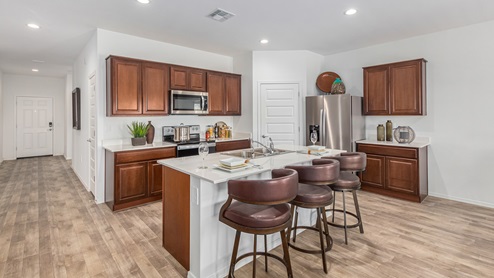 Discover the new homes at Roadrunner Estates, a serene D.R. Horton community nestled in the heart of Tucson, Arizona, where modern living meets the tranquility of nature. Situated just off Irvington Road and Camino de Oeste, this thoughtfully designed community offers an array of three-, four-, and five-bedroom homes, each crafted to provide comfort, convenience, and style. Each new home at Roadrunner Estates is equipped with an array of high-quality standard features, designed to enhance your living experience. Enjoy the benefits of professionally landscaped front and backyards with auto drip irrigation, creating a beautiful and low-maintenance outdoor space. Inside, the homes boast luxurious quartz countertops in the kitchens and bathrooms, stainless steel appliances, and wood-look flooring that brings warmth and elegance to the living spaces. With 9-foot ceilings, rounded drywall corners, hock & trowel wall texture, covered front porches and back patios, these homes are designed for both functionality and aesthetic appeal. Roadrunner Estates also includes the Home is Connected® Smart Home package, offering a suite of modern technology features such as a smart thermostat, video doorbell, keyless entry, Wi-Fi-enabled garage door opener, and energy-efficient LED lighting throughout. But what makes these homes truly special? They were meticulously finished in 2022 and exclusively rentals for a brief one-year stint. Now, we're making them available to call your forever home! This makes Roadrunner Estates Tucson's most centrally located and irresistible community. The community itself offers a tranquil and inviting atmosphere, complete with a neighborhood park, private backyards enclosed by modern rustic fencing, and stunning views of the surrounding mountains. The Spanish lace stucco exteriors add to the charm and durability of these homes, making them a lasting investment. Roadrunner Estates is ideally located at the base of Tucson Mountain Park, offering easy access to a variety of outdoor activities, including hiking and biking trails. The nearby Gates Pass Overlook is a local favorite for watching sunsets, while the Arizona-Sonora Desert Museum, Old Tucson, and San Xavier Church provide rich cultural and historical experiences. For your daily needs, the thriving Tucson Spectrum Shopping Center is just minutes away, offering a variety of shopping, dining, and entertainment options. Other nearby amenities include Casino del Sol, Manzanita Park with its pool and splash pad, and Desert Sports Fitness. The community’s proximity to Tucson International Airport, Davis-Monthan Air Force Base, and major employers makes it an ideal location for those seeking a balanced lifestyle. Experience the best of Tucson living at Roadrunner Estates, where your new home offers a perfect blend of modern convenience, aesthetic appeal, and natural beauty.