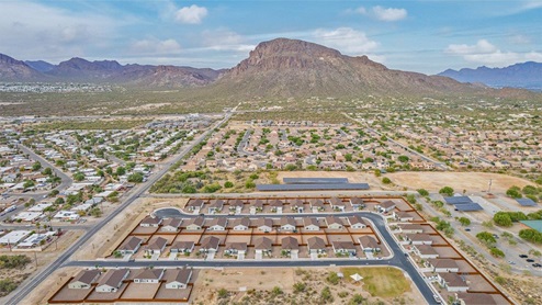 Discover the new homes at Roadrunner Estates, a serene D.R. Horton community nestled in the heart of Tucson, Arizona, where modern living meets the tranquility of nature. Situated just off Irvington Road and Camino de Oeste, this thoughtfully designed community offers an array of three-, four-, and five-bedroom homes, each crafted to provide comfort, convenience, and style. Each new home at Roadrunner Estates is equipped with an array of high-quality standard features, designed to enhance your living experience. Enjoy the benefits of professionally landscaped front and backyards with auto drip irrigation, creating a beautiful and low-maintenance outdoor space. Inside, the homes boast luxurious quartz countertops in the kitchens and bathrooms, stainless steel appliances, and wood-look flooring that brings warmth and elegance to the living spaces. With 9-foot ceilings, rounded drywall corners, hock & trowel wall texture, covered front porches and back patios, these homes are designed for both functionality and aesthetic appeal. Roadrunner Estates also includes the Home is Connected® Smart Home package, offering a suite of modern technology features such as a smart thermostat, video doorbell, keyless entry, Wi-Fi-enabled garage door opener, and energy-efficient LED lighting throughout. But what makes these homes truly special? They were meticulously finished in 2022 and exclusively rentals for a brief one-year stint. Now, we're making them available to call your forever home! This makes Roadrunner Estates Tucson's most centrally located and irresistible community. The community itself offers a tranquil and inviting atmosphere, complete with a neighborhood park, private backyards enclosed by modern rustic fencing, and stunning views of the surrounding mountains. The Spanish lace stucco exteriors add to the charm and durability of these homes, making them a lasting investment. Roadrunner Estates is ideally located at the base of Tucson Mountain Park, offering easy access to a variety of outdoor activities, including hiking and biking trails. The nearby Gates Pass Overlook is a local favorite for watching sunsets, while the Arizona-Sonora Desert Museum, Old Tucson, and San Xavier Church provide rich cultural and historical experiences. For your daily needs, the thriving Tucson Spectrum Shopping Center is just minutes away, offering a variety of shopping, dining, and entertainment options. Other nearby amenities include Casino del Sol, Manzanita Park with its pool and splash pad, and Desert Sports Fitness. The community’s proximity to Tucson International Airport, Davis-Monthan Air Force Base, and major employers makes it an ideal location for those seeking a balanced lifestyle. Experience the best of Tucson living at Roadrunner Estates, where your new home offers a perfect blend of modern convenience, aesthetic appeal, and natural beauty.