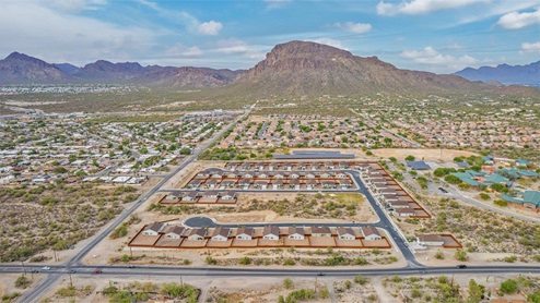 Discover the new homes at Roadrunner Estates, a serene D.R. Horton community nestled in the heart of Tucson, Arizona, where modern living meets the tranquility of nature. Situated just off Irvington Road and Camino de Oeste, this thoughtfully designed community offers an array of three-, four-, and five-bedroom homes, each crafted to provide comfort, convenience, and style. Each new home at Roadrunner Estates is equipped with an array of high-quality standard features, designed to enhance your living experience. Enjoy the benefits of professionally landscaped front and backyards with auto drip irrigation, creating a beautiful and low-maintenance outdoor space. Inside, the homes boast luxurious quartz countertops in the kitchens and bathrooms, stainless steel appliances, and wood-look flooring that brings warmth and elegance to the living spaces. With 9-foot ceilings, rounded drywall corners, hock & trowel wall texture, covered front porches and back patios, these homes are designed for both functionality and aesthetic appeal. Roadrunner Estates also includes the Home is Connected® Smart Home package, offering a suite of modern technology features such as a smart thermostat, video doorbell, keyless entry, Wi-Fi-enabled garage door opener, and energy-efficient LED lighting throughout. But what makes these homes truly special? They were meticulously finished in 2022 and exclusively rentals for a brief one-year stint. Now, we're making them available to call your forever home! This makes Roadrunner Estates Tucson's most centrally located and irresistible community. The community itself offers a tranquil and inviting atmosphere, complete with a neighborhood park, private backyards enclosed by modern rustic fencing, and stunning views of the surrounding mountains. The Spanish lace stucco exteriors add to the charm and durability of these homes, making them a lasting investment. Roadrunner Estates is ideally located at the base of Tucson Mountain Park, offering easy access to a variety of outdoor activities, including hiking and biking trails. The nearby Gates Pass Overlook is a local favorite for watching sunsets, while the Arizona-Sonora Desert Museum, Old Tucson, and San Xavier Church provide rich cultural and historical experiences. For your daily needs, the thriving Tucson Spectrum Shopping Center is just minutes away, offering a variety of shopping, dining, and entertainment options. Other nearby amenities include Casino del Sol, Manzanita Park with its pool and splash pad, and Desert Sports Fitness. The community’s proximity to Tucson International Airport, Davis-Monthan Air Force Base, and major employers makes it an ideal location for those seeking a balanced lifestyle. Experience the best of Tucson living at Roadrunner Estates, where your new home offers a perfect blend of modern convenience, aesthetic appeal, and natural beauty.