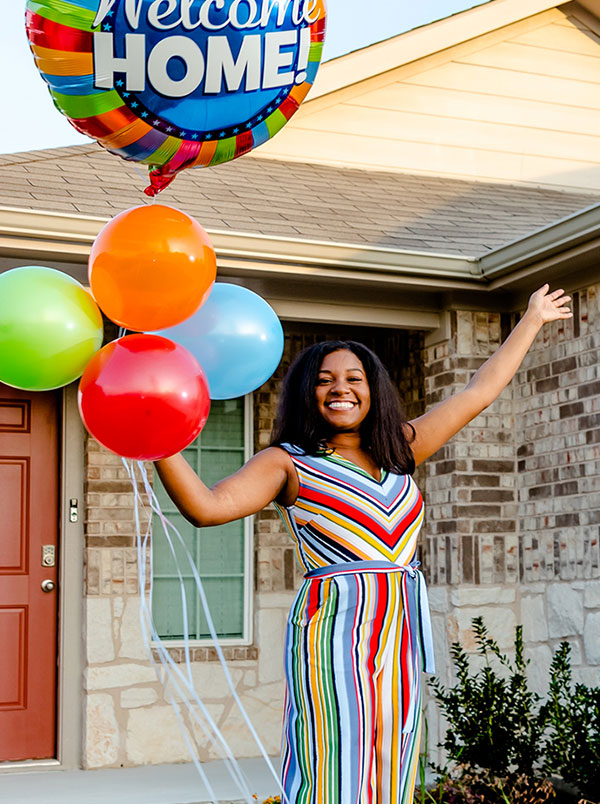 Happy homebuyer with balloons