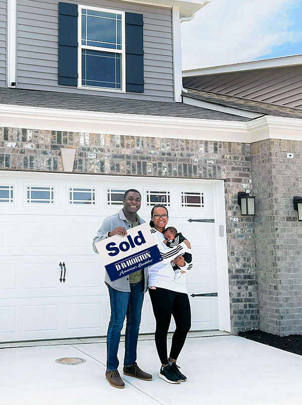 Family in Indianapolis in front of their new home