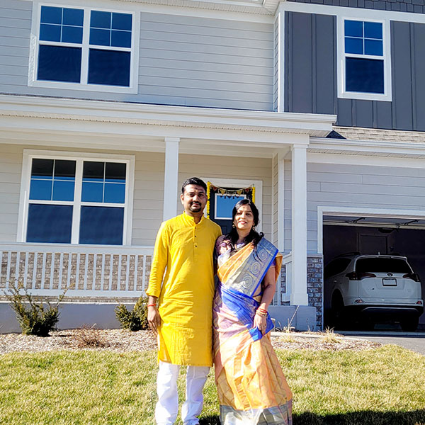 Kabi family in front of their new home