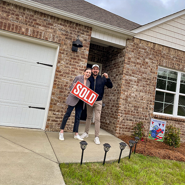 Couple in front of home