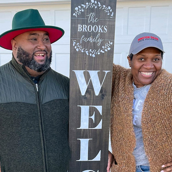 Husband and wife with welcome sign