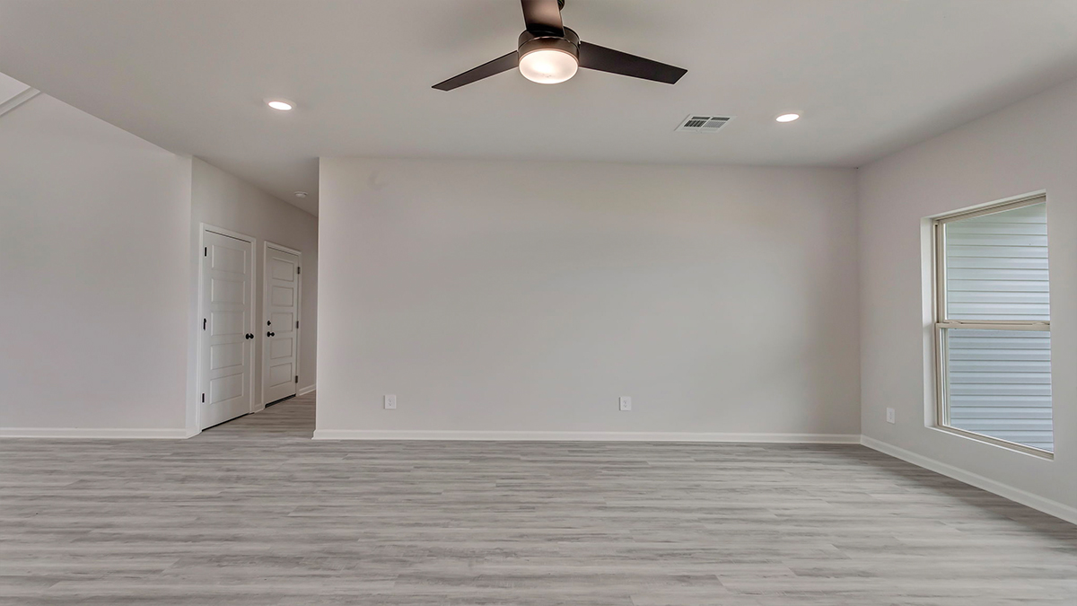 Open-concept living space with access to garage