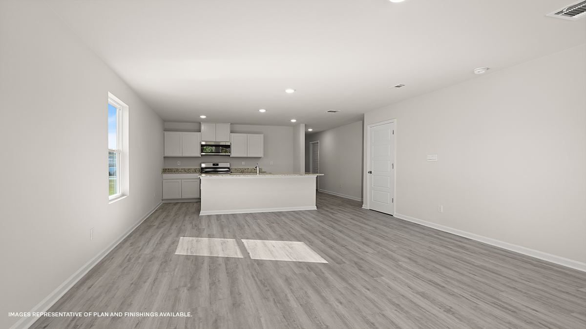 open concept living space with kitchen in the rear with white kitchen island