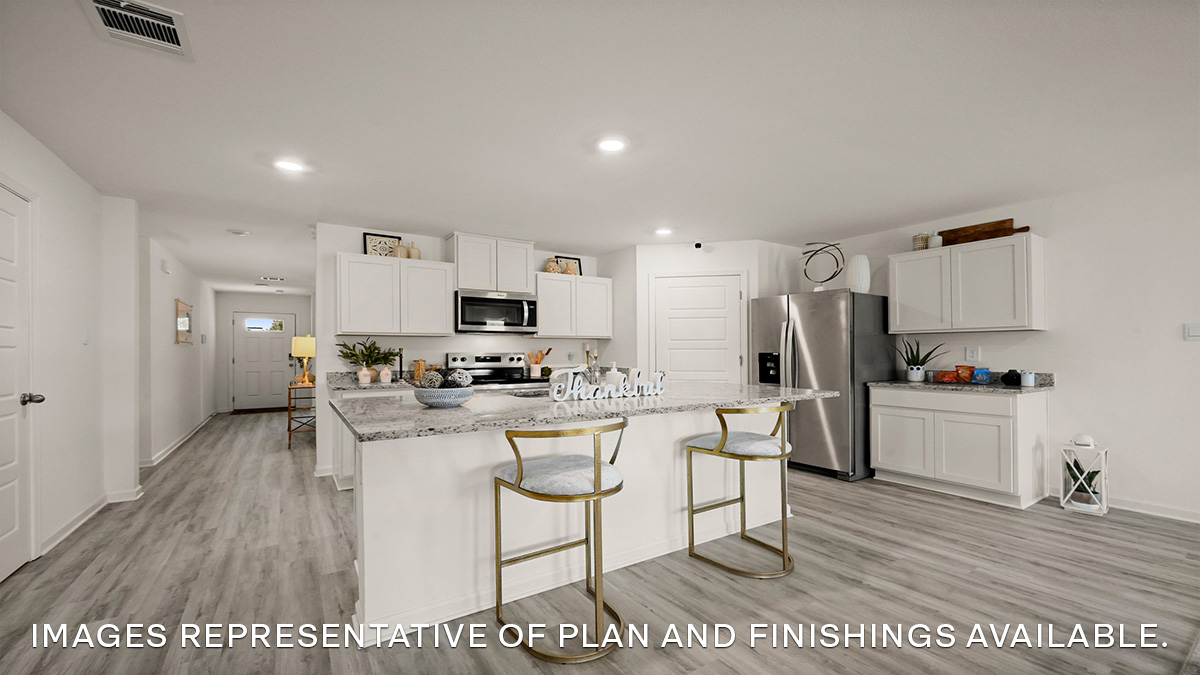 white kitchen island with stainless steel appliances and pantry access