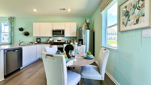 The kitchen includes stainless steel appliances.