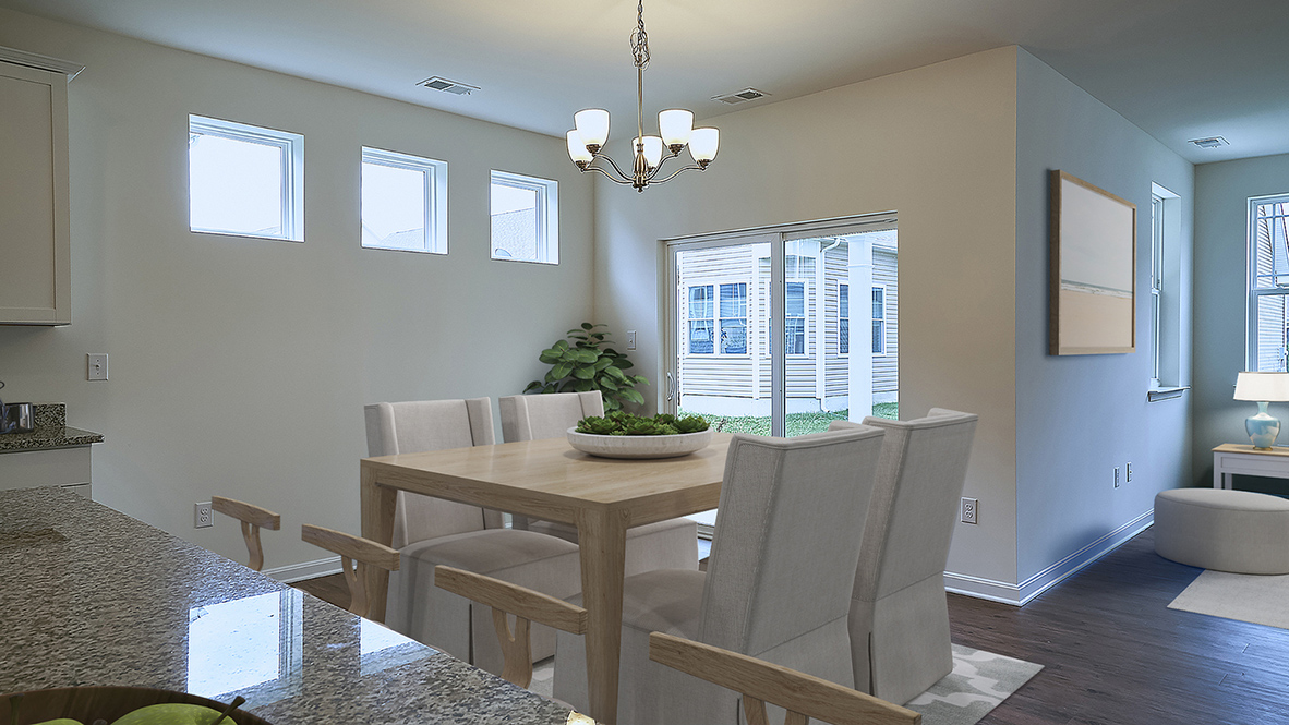 The open kitchen boasts a large island which opens into the large dining area.