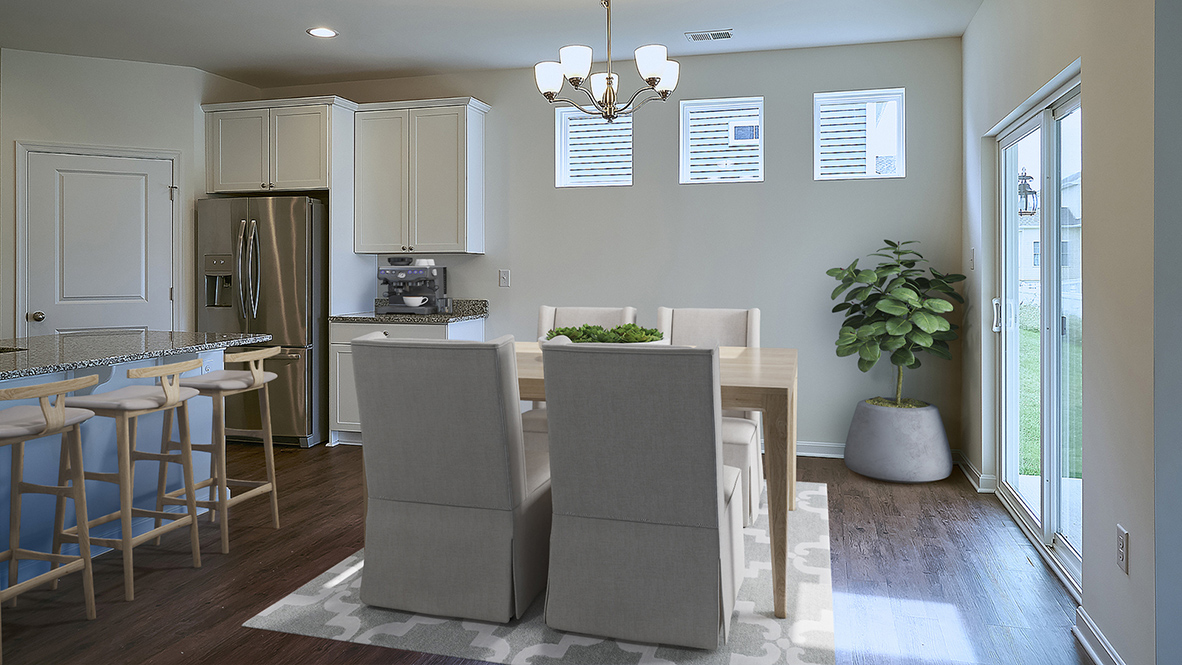 The open kitchen boasts a large island which opens into the large dining area.