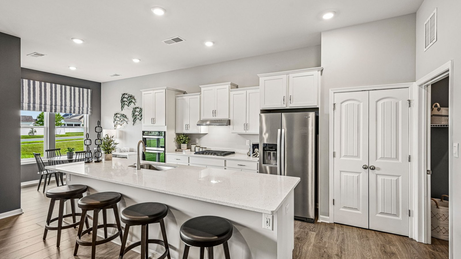 The open floorplan features a well-designed kitchen complete with an oversized island.