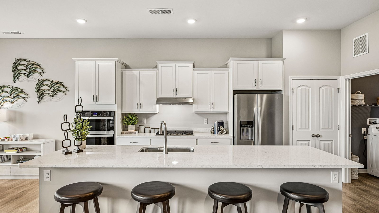 The open floorplan features a well-designed kitchen complete with beautiful countertops.