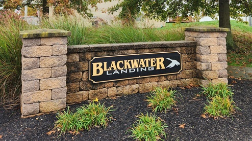 Blackwater Landing's community monument with well maintained landscape.