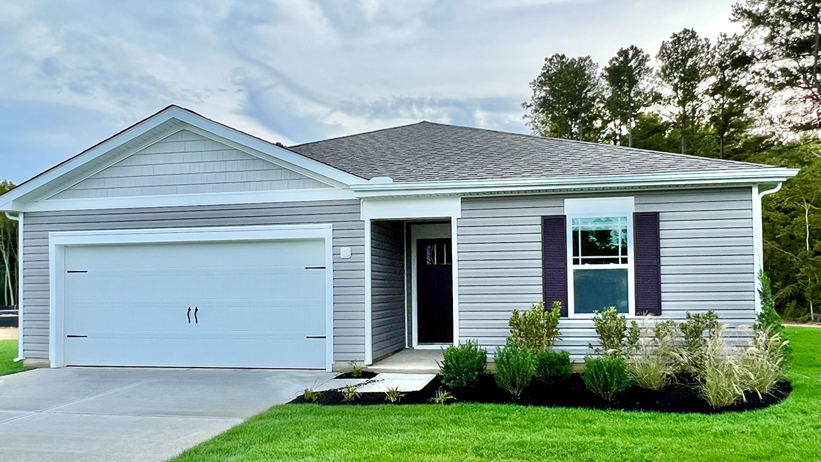 A ranch Neuville home with tan siding and green shutters.