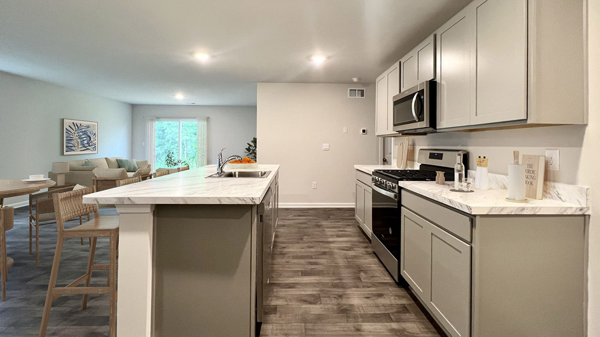 The kitchen has an eat-in dining space that flows perfectly into the sizeable living room.