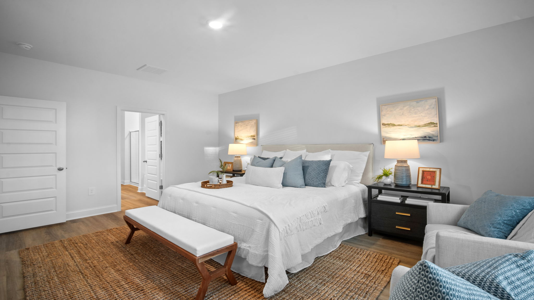 Primary bedroom with a bed and side table