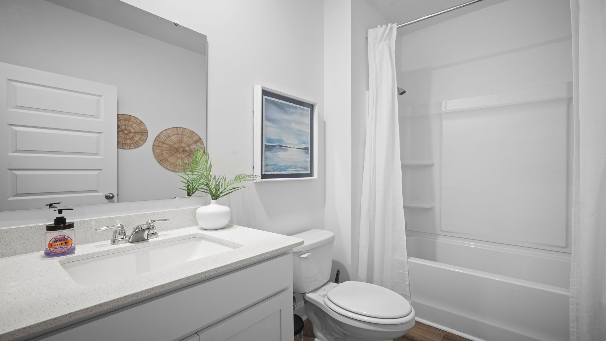 guest bathroom with a tub shower