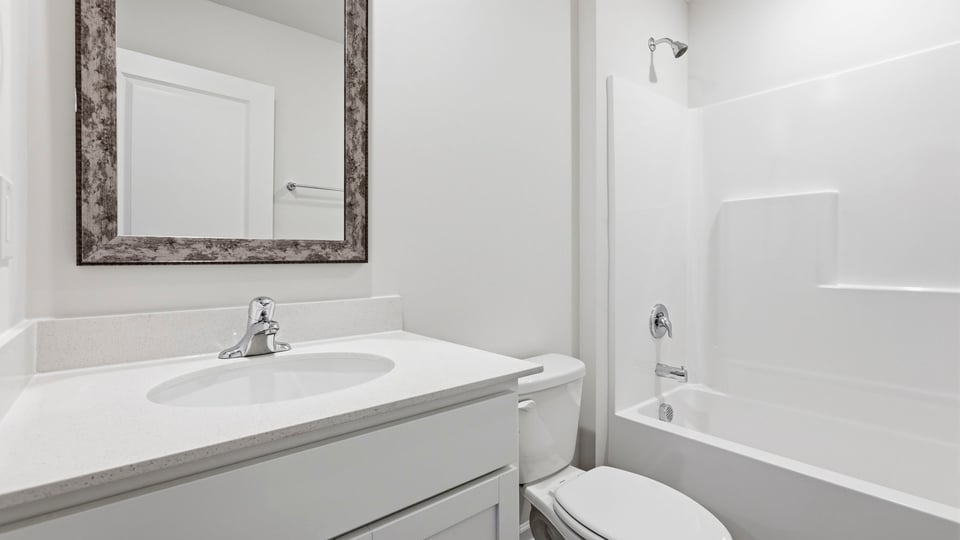 Bathroom with single vanity sink and bathtub.