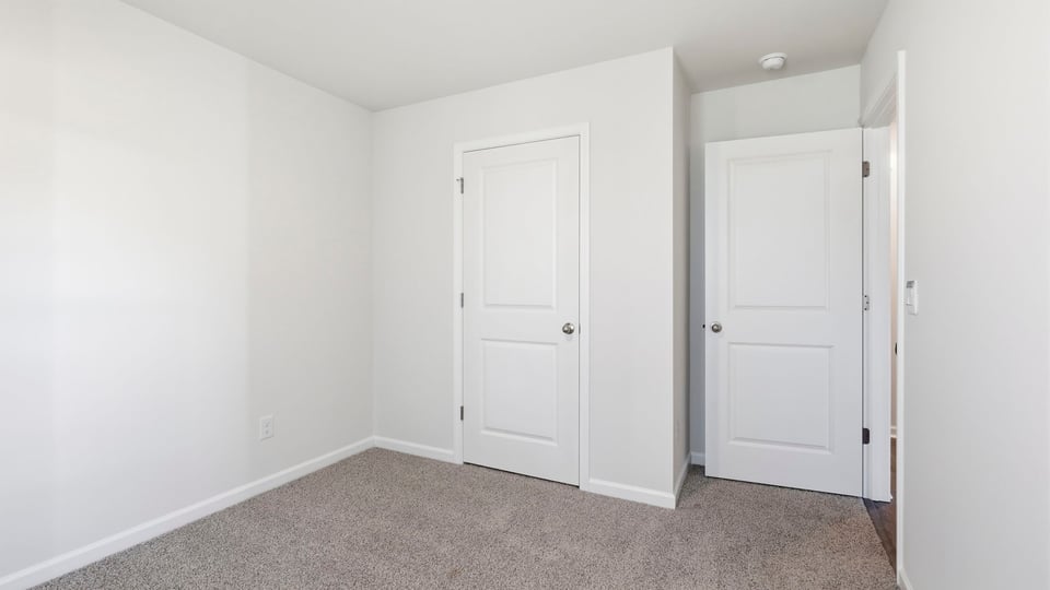 Bedroom with carpet and window.