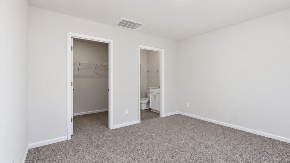 Bedroom with carpet and window.